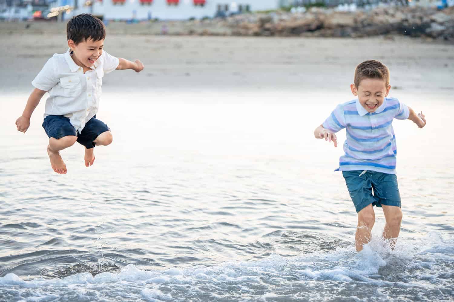 Two boys splashing in the ocean at short sands beach in York Maine