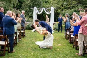 Bride and Groom dip kiss at the end of their ceremony at Josia's River Farm in York Maine