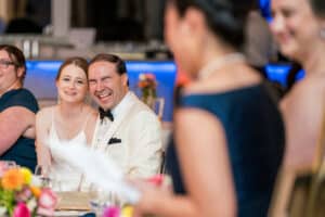 The couple laughs during speeches at their Danversport Wedding in Danversport, MA