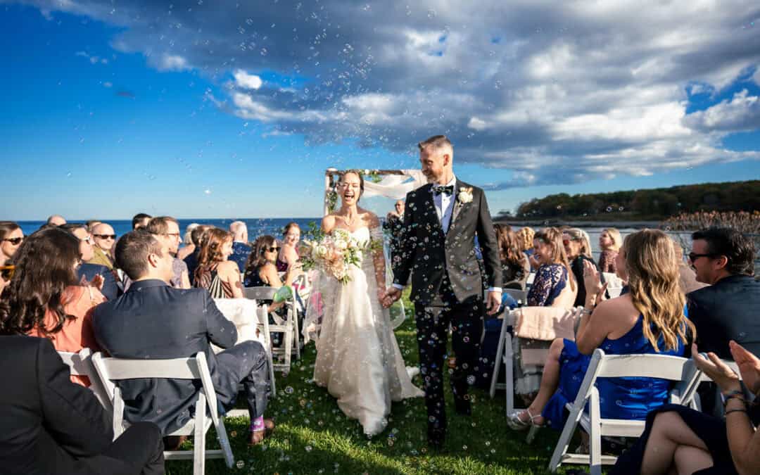 Couple celebrates after their ceremony with a bubble exit at their Stage Neck Inn Wedding in York Maine