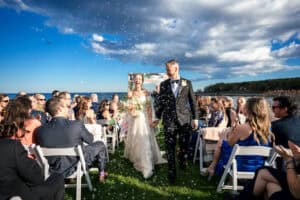 Couple celebrates after their ceremony with a bubble exit at their Stage Neck Inn Wedding in York Maine
