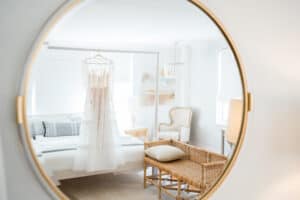 Custom Wedding gown hangs in the bridal suite of the 1774 Inn in Phippsburg, Maine