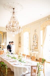 Two grooms in the ballroom of a Newport Mansion wedding