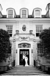 A couple poses outside of a Mansion for their Newport Mansion wedding