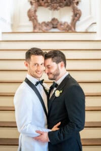 Two grooms pose for a Newport Mansion Wedding