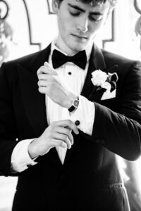 Groom adjusts his cufflinks for a Newport Mansion Wedding