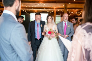 1774 Inn Wedding Photographer captures the bride walking down the aisle with her father and step father