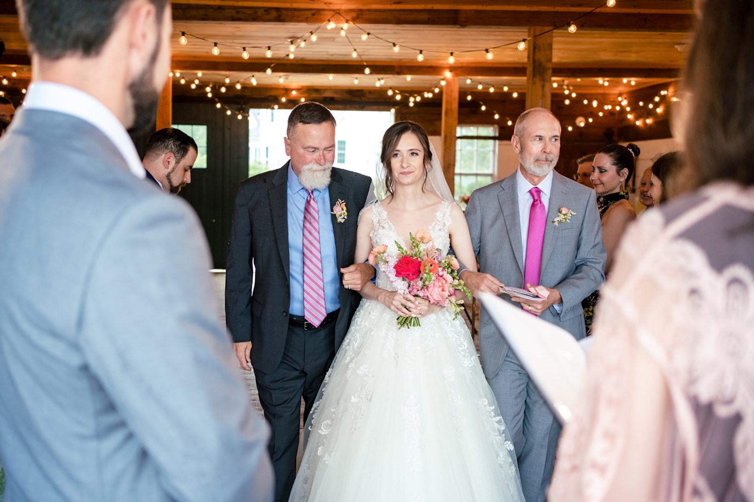 1774 Inn Wedding Photographer captures the bride walking down the aisle with her father and step father
