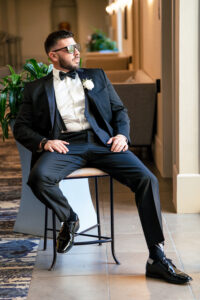 Groom gets ready in a GQ style groom photo at the Danversport Yacht Club Wedding