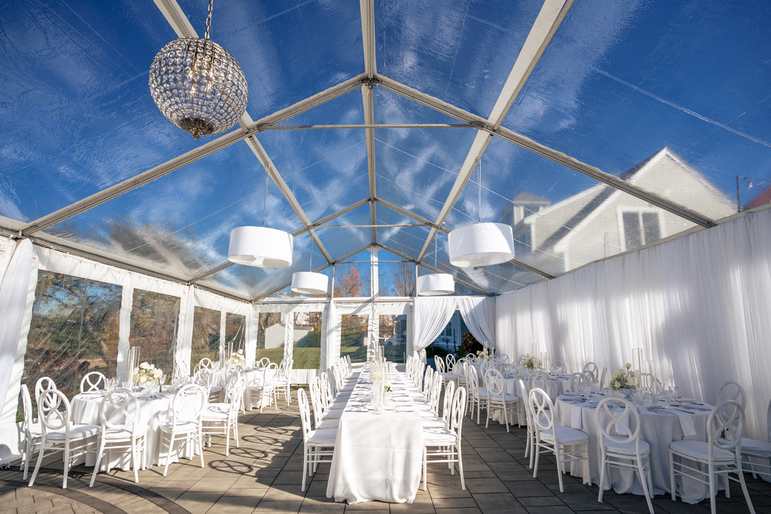 A white wedding theme for a clear top tent wedding. Captured by Maine Wedding Photographers, Two Adventurous Souls