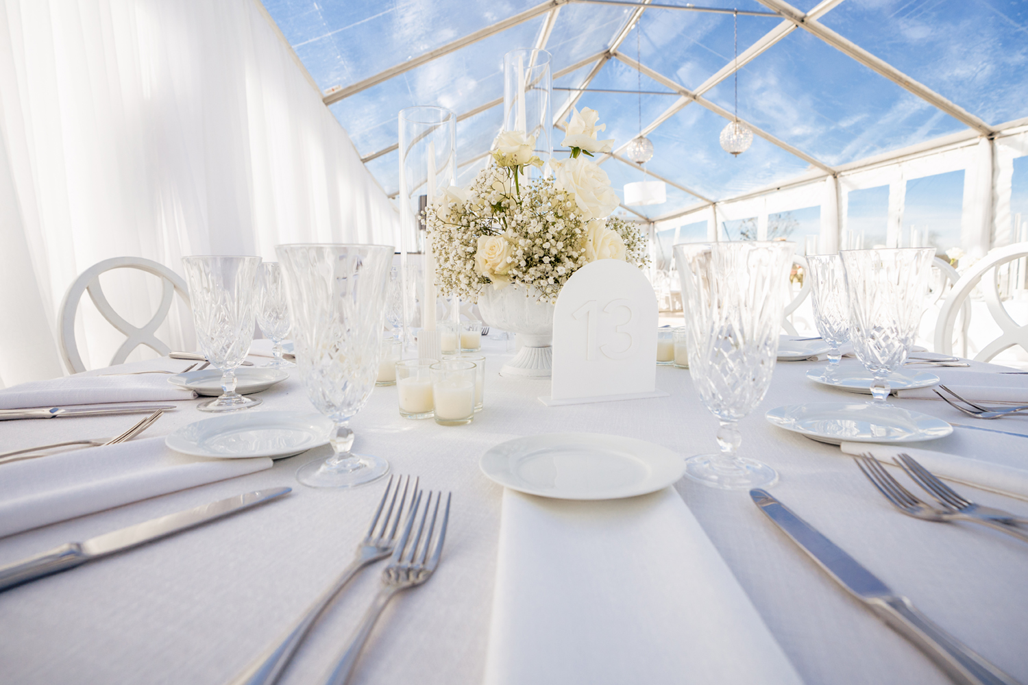 A white wedding theme for a clear top tent wedding. Captured by Maine Wedding Photographers, Two Adventurous Souls