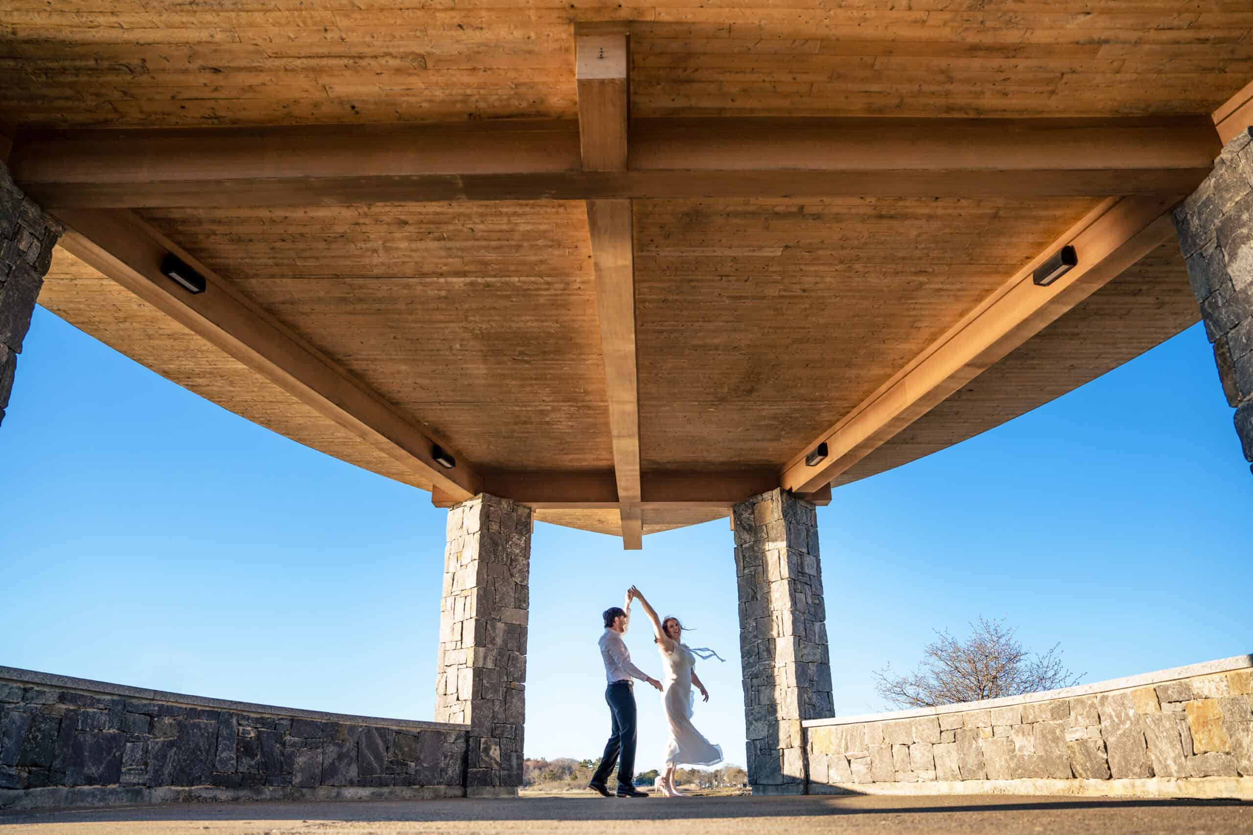 Couple dances under a gazebo for their engagement session on the campus of University of New England. For their Biddeford Pool wedding