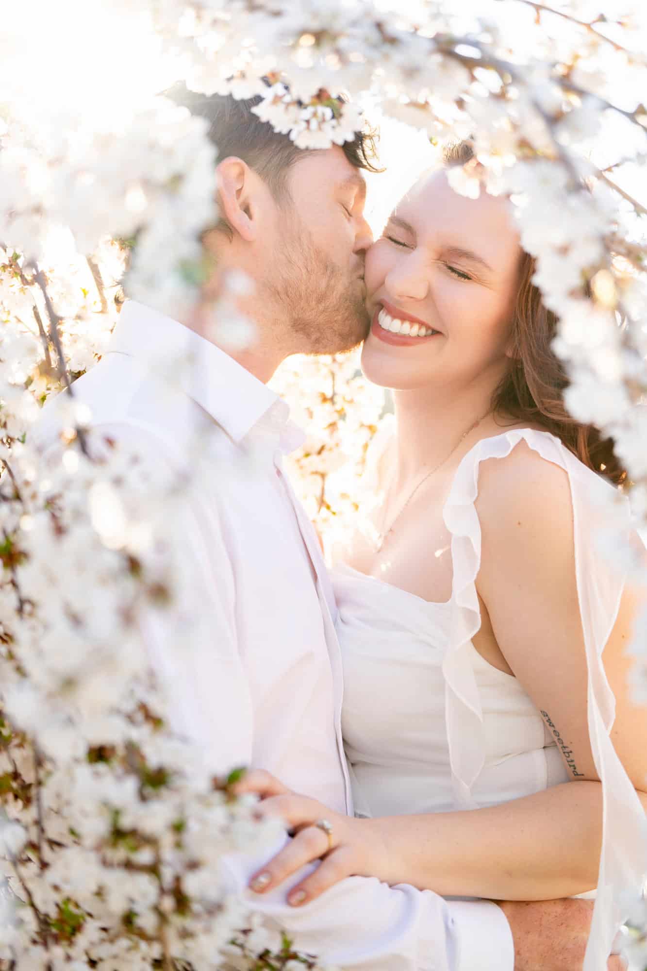 Wedding Couple posing under a flowering tree for their Biddeford Pool Wedding