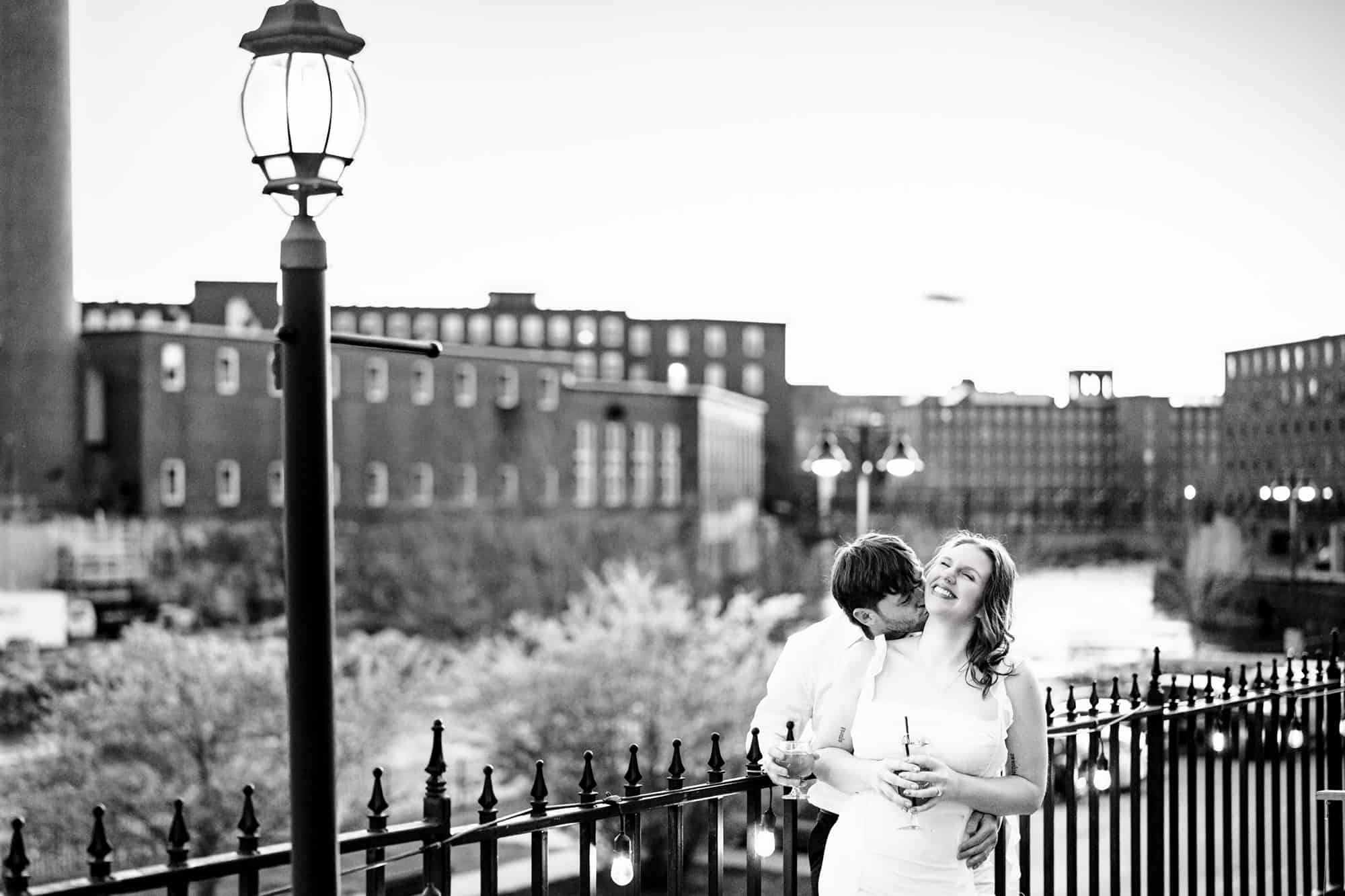 Couple poses on the patio of Run of the Mill in Saco Maine for their Biddeford Pool Wedding